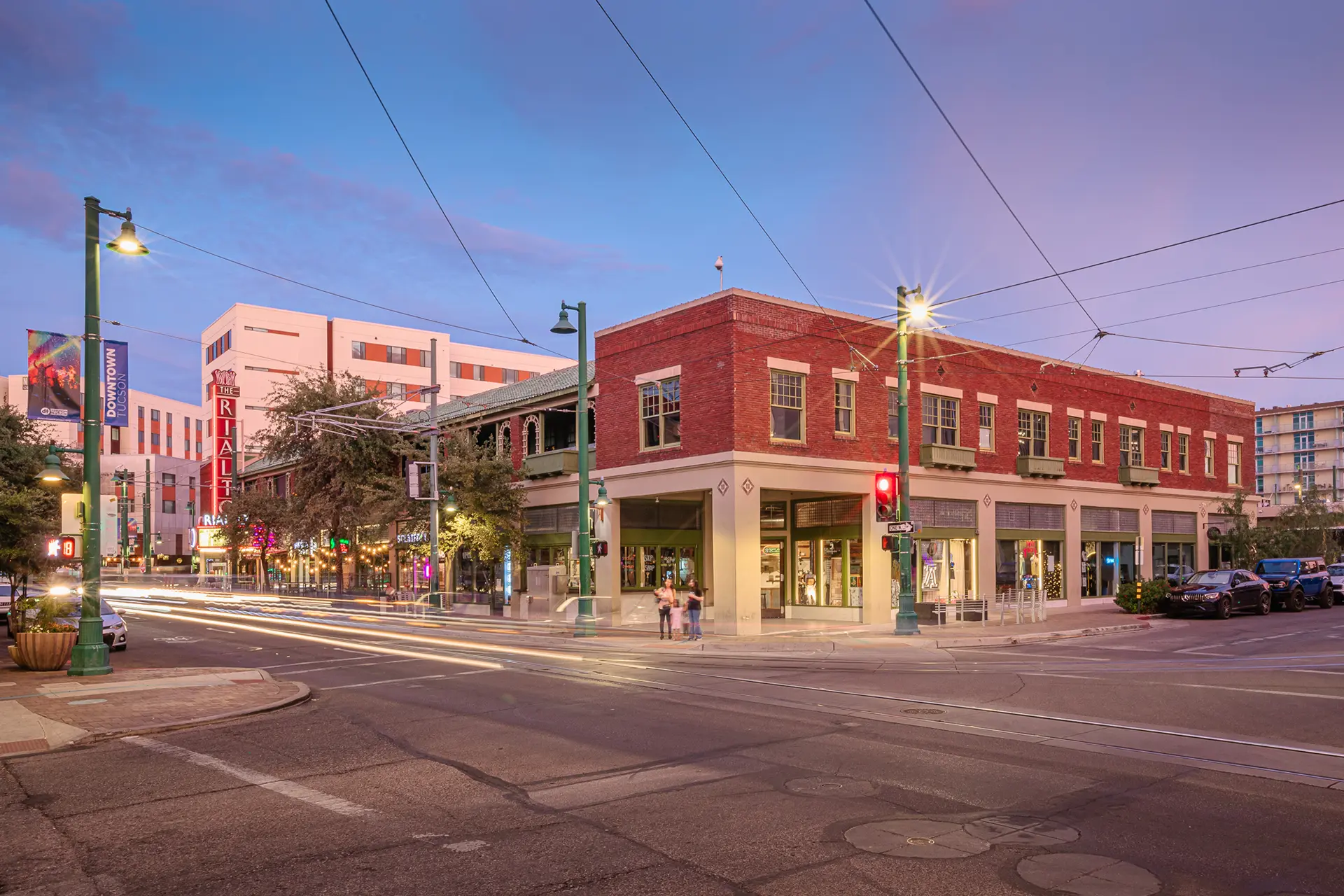 Red brick buildings and tram lines at an intersection near The Rialto. Commercial Real Estate and Property Management in downtown Tucson